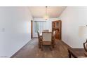 Traditional dining room with carpet, a wooden table set, and a decorative hutch at 2086 Angel Falls Dr, Henderson, NV 89074