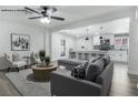 Inviting living room with open floor plan, modern furniture, and kitchen access featuring a center island at 2729 Flower Ave, North Las Vegas, NV 89030