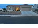 Charming single-story home with desert landscaping and a tile roof as dusk approaches at 2736 Darby Falls Dr, Las Vegas, NV 89134