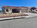 Charming single-story home with desert landscaping and a tile roof on a sunny day at 2736 Darby Falls Dr, Las Vegas, NV 89134