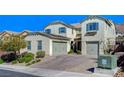 Attractive home boasts a two-car garage, well-maintained landscaping, and brick driveway at 352 Sidewheeler St, Henderson, NV 89012