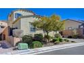 Attractive home boasts a two-car garage, well-maintained landscaping, and brick driveway at 352 Sidewheeler St, Henderson, NV 89012