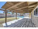 Backyard patio includes wooden pergola, concrete patio and in-ground pool, enhancing the outdoor living space at 3577 Wayne Cir, Las Vegas, NV 89121