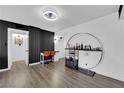 Modern dining space featuring a stylish bar area, chic decor, and sleek black accent wall at 3930 University Center Dr # 909, Las Vegas, NV 89119