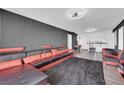 Bright living room showcasing a stylish black and red sectional, textured wall, and modern decor at 3930 University Center Dr # 909, Las Vegas, NV 89119