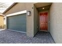 Exterior view of a one-story house showing garage, brick driveway and front door at 4227 Diya Ave, North Las Vegas, NV 89084