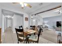 Charming dining area with a wood table and access to a living room with blue walls and lots of natural light at 4655 Fire Fly Cir, Las Vegas, NV 89122