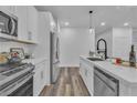 Bright kitchen with white cabinets, stainless steel appliances, and durable flooring at 600 N Carriage Hill Dr # 1164, Las Vegas, NV 89138