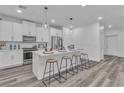 Open kitchen with a large island, seating, stainless steel appliances, and pendant lighting at 600 N Carriage Hill Dr # 1164, Las Vegas, NV 89138