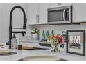 Close up of kitchen with stainless steel appliances, white countertops and modern faucet at 600 N Carriage Hill Dr # 1164, Las Vegas, NV 89138