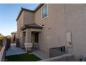 Home exterior highlighting the side yard access and neutral paint tones, plus front patio at 717 W Colton Ave, North Las Vegas, NV 89032