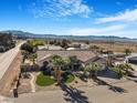 Expansive view of a charming home with desert landscaping, palm trees, and a two-car garage at 78 Siddall Ave, Las Vegas, NV 89183