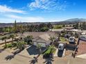 Aerial view of a charming home with a two-car garage, RV parking, and desert landscaping at 78 Siddall Ave, Las Vegas, NV 89183