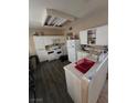 Functional kitchen with white appliances and laminate flooring at 8124 Kokoma Dr, Las Vegas, NV 89128