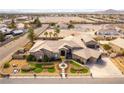 Stunning aerial view of home with desert landscaping and circular driveway at 8925 Silent Brook Ct, Las Vegas, NV 89149