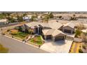Aerial view of luxury home with three-car garage and well-manicured landscaping at 8925 Silent Brook Ct, Las Vegas, NV 89149