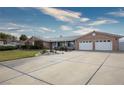 Single story home with a long driveway, mature landscaping, and a two-car garage at 904 Hibiscus Ct, Henderson, NV 89011