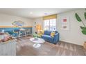 Cozy bonus room featuring comfortable seating, stylish decor, and a bright window view at 1025 Gentle Swan St # 690, Henderson, NV 89011