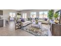 Bright living room with large windows, tile flooring, and an open layout at 1027 Gentle Swan St # 689, Henderson, NV 89011