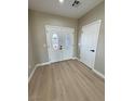 Inviting foyer with double front doors, wood-look floors and neutral paint at 1131 Lupin St, Pahrump, NV 89048