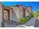 Inviting exterior view with a pathway and manicured green bushes at 11356 Belmont Lake Dr # 103, Las Vegas, NV 89135