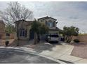Two-story stucco home featuring arched entry and driveway at 11769 Via Vera Cruz Ct, Las Vegas, NV 89138