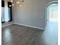Bright living room with arched entry and hardwood floors at 11769 Via Vera Cruz Ct, Las Vegas, NV 89138