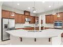 Modern kitchen featuring a large island with stainless steel appliances and custom cabinetry at 11843 Cogoleto Ave, Las Vegas, NV 89138