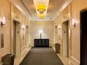 Elevator lobby with tiled walls and floors, plus modern lighting and furnishings at 125 E Harmon Ave # 1003, Las Vegas, NV 89109