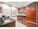 Classic kitchen with wood cabinets, stainless steel appliances, and black countertops at 145 Harmon Ave # 1021, Las Vegas, NV 89109
