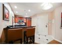 Cozy kitchen with a breakfast bar featuring granite counters and stainless steel appliances at 145 Harmon Ave # 1021, Las Vegas, NV 89109