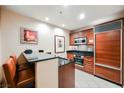 Charming kitchen area featuring wood cabinets, a breakfast bar, and stainless steel appliances at 145 Harmon Ave # 1021, Las Vegas, NV 89109