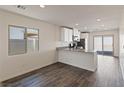 Open-concept kitchen with counter seating, modern appliances, and a seamless transition to the dining area at 1713 Desert Path Ave, North Las Vegas, NV 89032