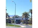 Gated community entrance with lush landscaping, decorative architecture, and clear blue skies at 172 Tall Ruff Dr, Las Vegas, NV 89148