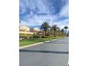 Street view showcasing well-maintained lawns, mature palm trees, and beautiful neighborhood homes at 172 Tall Ruff Dr, Las Vegas, NV 89148