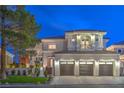 Magnificent two-story home with a three-car garage and a balcony, illuminated against the night sky at 1912 Glenview Dr, Las Vegas, NV 89134