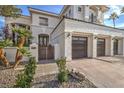 Elegant home exterior showcasing lush landscaping, a three-car garage, and a gated entrance leading to the front door at 1912 Glenview Dr, Las Vegas, NV 89134