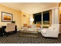 Inviting living room with city views, a sofa, chair, desk, and stylish decor at 2000 Fashion Show Dr # 2604, Las Vegas, NV 89109