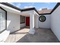 Covered entrance with stately columns and a bright red front door at 2222 Little River Ct, Las Vegas, NV 89156