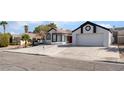Inviting home with well-maintained lawn, desert landscaping, and large driveway at 2222 Little River Ct, Las Vegas, NV 89156