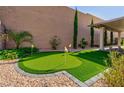 Backyard putting green providing a recreational amenity with manicured turf and privacy wall at 2341 Rosendale Village Ave, Henderson, NV 89052