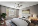 Calm bedroom with a plush bed, soft lighting from bedside lamps, and a relaxing view out of the window at 2555 Hampton Rd # 4204, Henderson, NV 89052