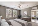 Serene bedroom with a ceiling fan, large windows, and a workspace, offering comfort and functionality at 2555 Hampton Rd # 4204, Henderson, NV 89052