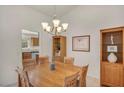 Cozy dining area with wooden table set, chandelier, and built-in display cabinet at 2628 Showcase Dr, Las Vegas, NV 89134