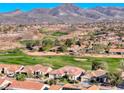 Beautiful aerial shot of a home in a lush golf course community with mountain views at 2872 Sumter Valley Cir, Henderson, NV 89052