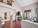 Spacious living room features a stone fireplace, vaulted ceiling, and wood floors at 353 Seine Way # 0, Henderson, NV 89014