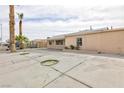 Expansive backyard with concrete flooring, a covered patio and palm trees at 4213 Hayes Pl, Las Vegas, NV 89107
