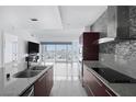 Open concept kitchen features an island and views of the city skyline at 4471 Dean Martin Dr # 1202, Las Vegas, NV 89103