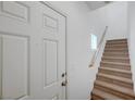 Clean entryway with a white door and carpeted stairs, offering a welcoming first impression at 470 Dorchester Bend Ave # 3, North Las Vegas, NV 89032