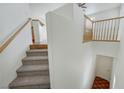 Staircase with carpeted steps and decorative wood railing leading to the upper level of the home at 470 Dorchester Bend Ave # 3, North Las Vegas, NV 89032
